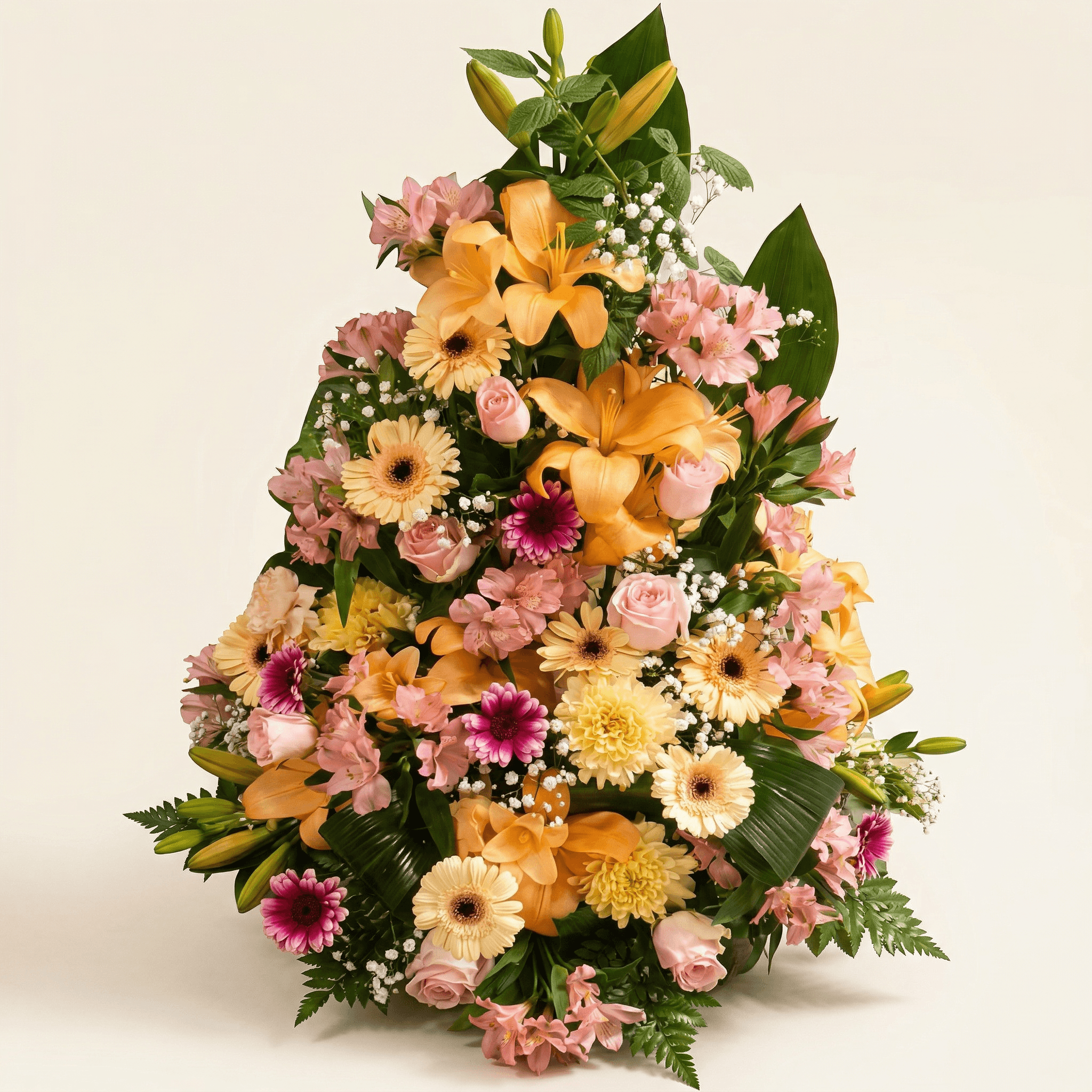 Stående sorgarrangemang med liljor och rosor